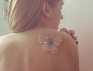 29 White ink butterfly tattoo on back