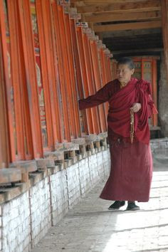 ... Tibetan monk turning prayer wheels - Tongren, Tibet - photo - staci j