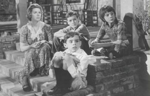 Here is a picture of Miss Maudie with Dill, Jem and Scout.