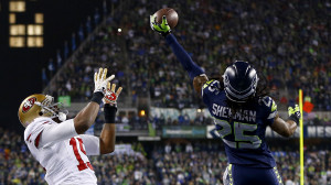 ... Sherman #25 of the Seattle Seahawks tips the ball up in the air