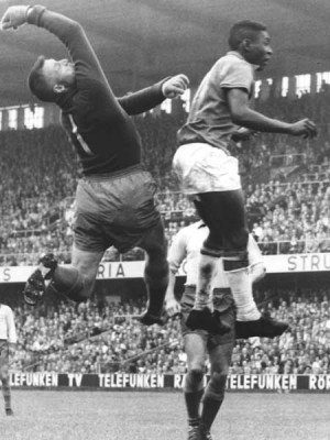 Pelé fighting for a ball against the Swedish goalkeeper Kalle ...