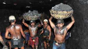Indian coal miners at work in a mine at Godavarikhani, some 250km east ...
