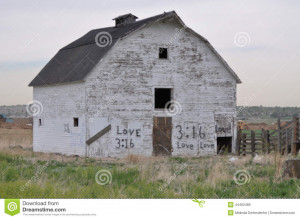 Old white barn out in the country displays the workings of graffiti ...