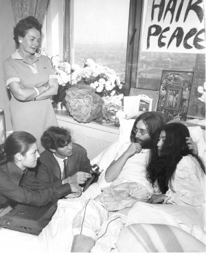 John Lennon and Yoko Ono being interviewed by the press during their ...