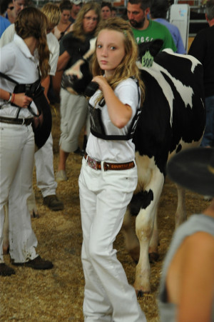 Confident young lady leading her charge to the judging.