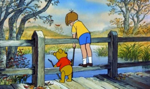 Winnie the Pooh and Christopher Robin having a chat on a bridge