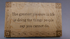 small wood burning sign with quote and border