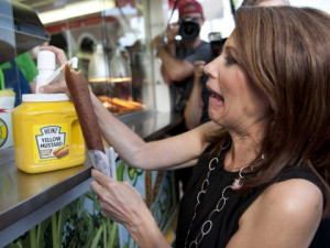 ... Michele Bachmann putting mustard on a corn dog at the Iowa State Fair