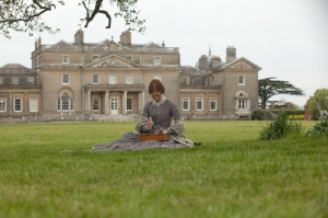 Jane Eyre 2011 Movie Review: Jane sitting onthe grass at thornfield