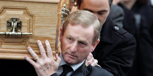 Taoiseach Enda Kenny carries his mother's coffin at Monday's funeral.