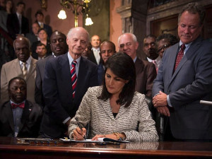 Gov. Nikki Haley signs a bill into law that removed the Confederate ...
