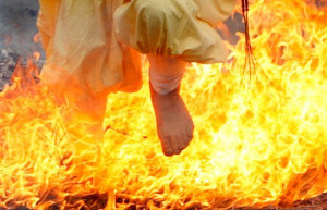 runs through flames during the Nagatoro Fire Festival, a fire-walking ...