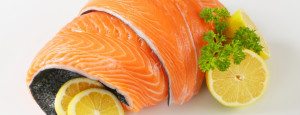 roll of salmon fillet and orange slices