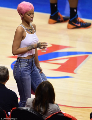 Attention grabbing: Rihanna went braless in her skimpy white top ...