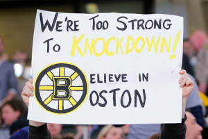 fan holds a sign during a Boston Bruins hockey game after the marathon ...