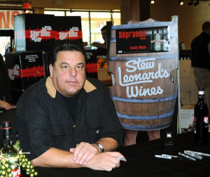 Steve Schirripa signs wine bottles at the Soprano Wine Bottle Signing