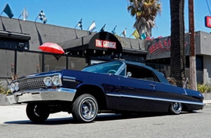 Those rims on his Chevrolet Impala.