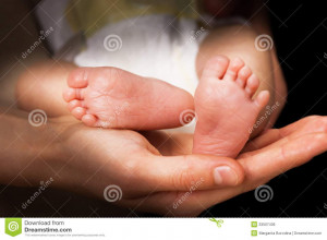 Royalty Free Stock Image: Moms hands holding baby s feet