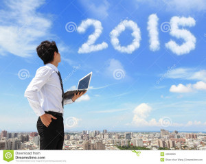 Young business man using laptop and look to 2015 year text with blue ...
