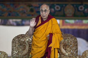 FILE - Tibetan spiritual leader the Dalai Lama gestures to devotees ...