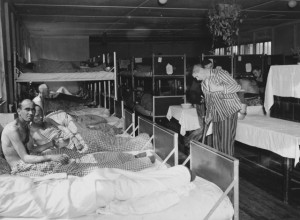 survivor sweeps the floor of the infirmary in the Dachau concentration ...