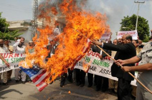 Pakistani lawyers burn a U.S. flag while rallying in reaction to a ...