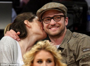 Loved up: The couple get cosy at an LA Lakers game in April 2009