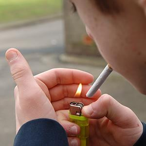 Teenager lighting a cigarette (© Diverse Images/UIG/Getty Images)
