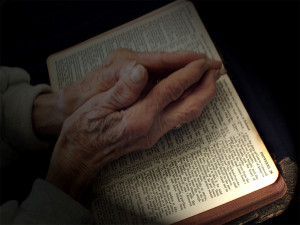 stockvault-praying-hands-on-bible107474.jpg