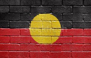 Stock photo : Flag of Aborigines painted onto a grunge brick wall