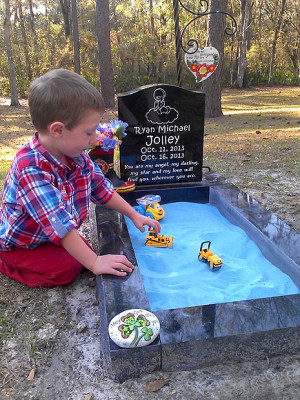 ... atop her son's grave, so 3-year-old Tucker can play with his brother