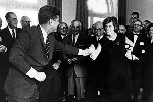 President John F. Kennedy hands his sister, Eunice Kennedy Shriver ...