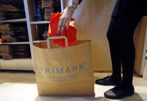 sales assistant packs clothes at a Primark store on Oxford Street in ...