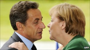 French President Nicholas Sarkozy kisses his German counterpart Angela ...