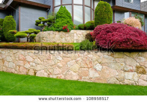 flowers and nicely trimmed bushes on the leveled front yard. Landscape ...