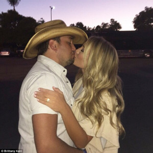 ... Jason Aldean kisses fiance Brittany Kerr as she shows off her new rock