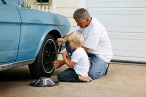 The boy is helping his father.