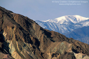 Snow-capped mountain and barren eroded hills, Death Valley National ...