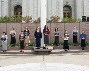 photo of ten sister missionaries with name badges and signs ...