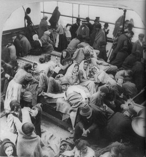 Immigrants on Ellis Island. Photo by William H. Rau. Public domain.