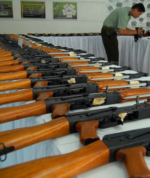 policeman takes a video of 100 AK-47 assault rifles confiscated in a ...