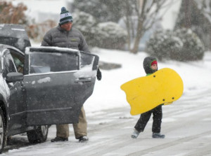 Chris Brown and his son Lucas, 6, get ready to have fun sledding ...