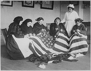Patriotic women, who had emigrated to America, work on the flag in ...