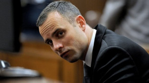 South African Paralympic athlete Oscar Pistorius sits in the dock ...