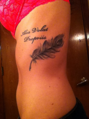 Wing tattoo with Latin quote. 