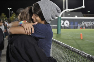 boy, couple, cute, cute couple, football game, girl, happy, hugging ...