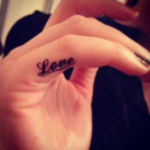 See more Bold love ink tattoo on small finger