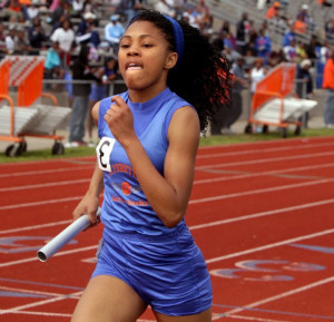 East St. Louis' D'Neesha Hamiel runs runs a leg of a sprint medley at ...