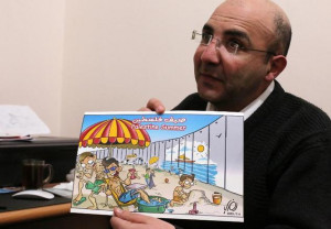 Palestinian cartoonist Ramzy Taweel shows one of his drawing on ...