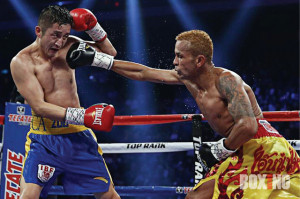 Amnat Ruenroeng R of Thailand punches double Olympic flyweight